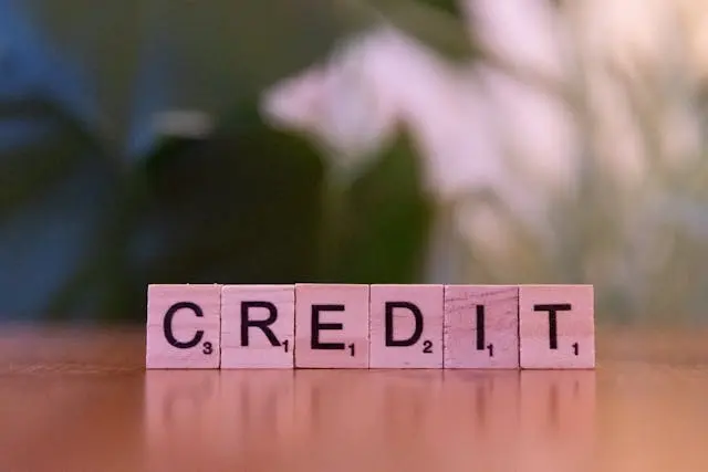 Wooden letter tiles spelling “CREDIT” on desk for credit risk modeling concepts